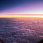 Sunrise over clouds seen from airplane window