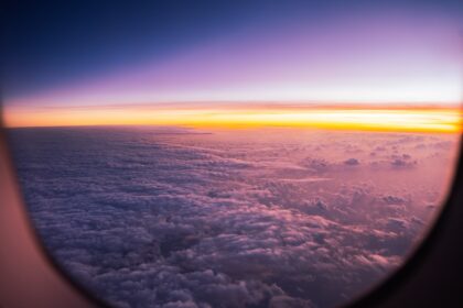 Sunrise over clouds seen from airplane window